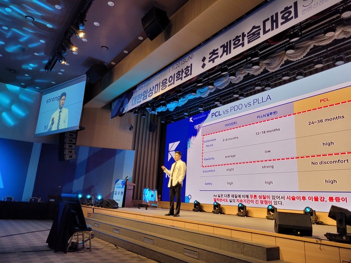 대한임상미용의학회 추계학술대회 무대에서 실 성분 비교 자료를 띄우고 발표하는 장면
